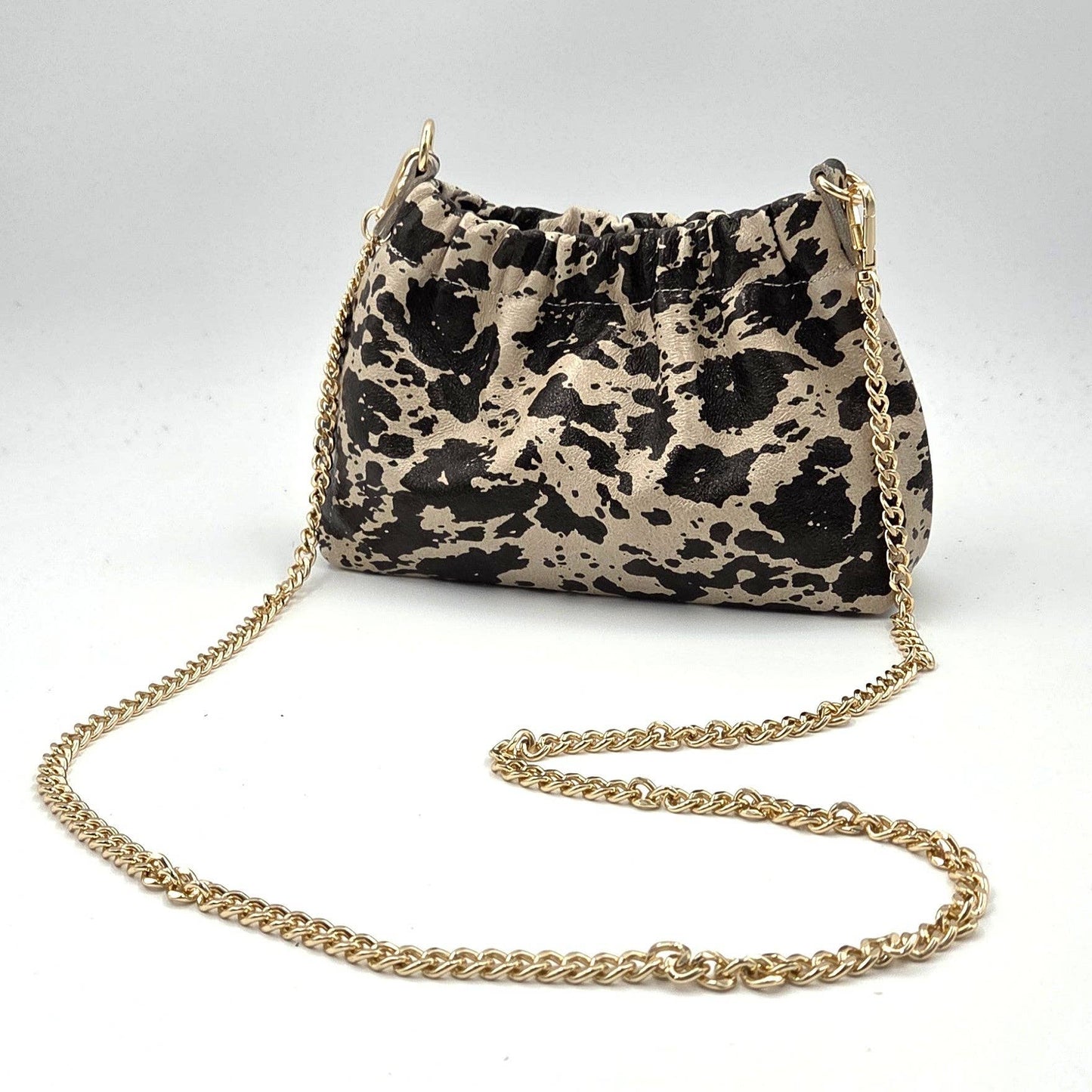 Animal print leather ruched opening clutch bag with chain crossbody